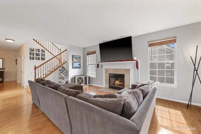 a living room with furniture a flat screen tv and a fireplace