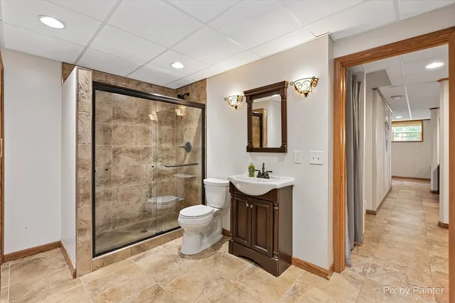 a bathroom with a sink toilet a mirror and shower