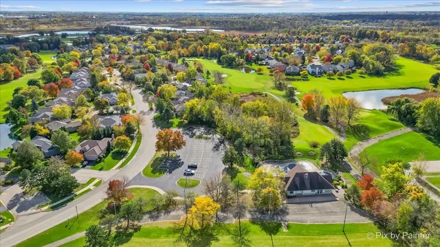 an aerial view of a houses with a lake view