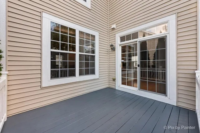 a view of front door with wooden floor and a window