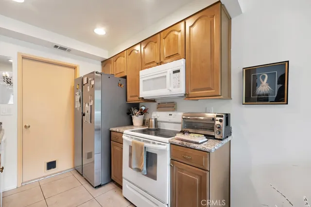 a kitchen with stainless steel appliances a refrigerator sink and cabinets