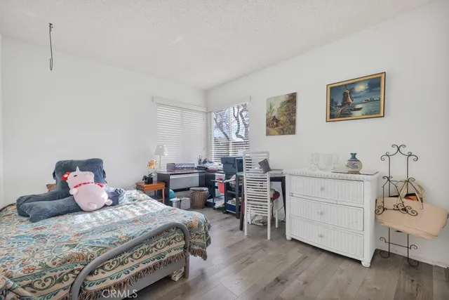 a bedroom with a bed and a desk