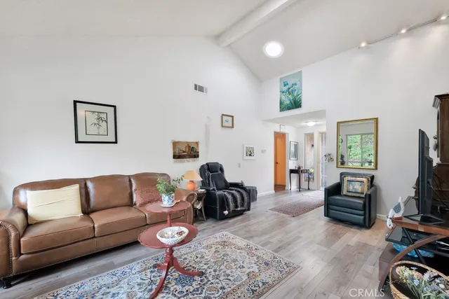 a living room with furniture a flat screen tv and a couch