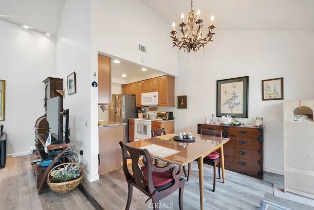 a view of a dining room with furniture and a chandelier