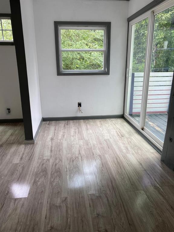 7312 Tanglewood Frankston, TX 75763 - Photo 4 of 7 an empty room with wooden floor and windows