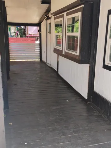 a view of an entryway with wooden floor