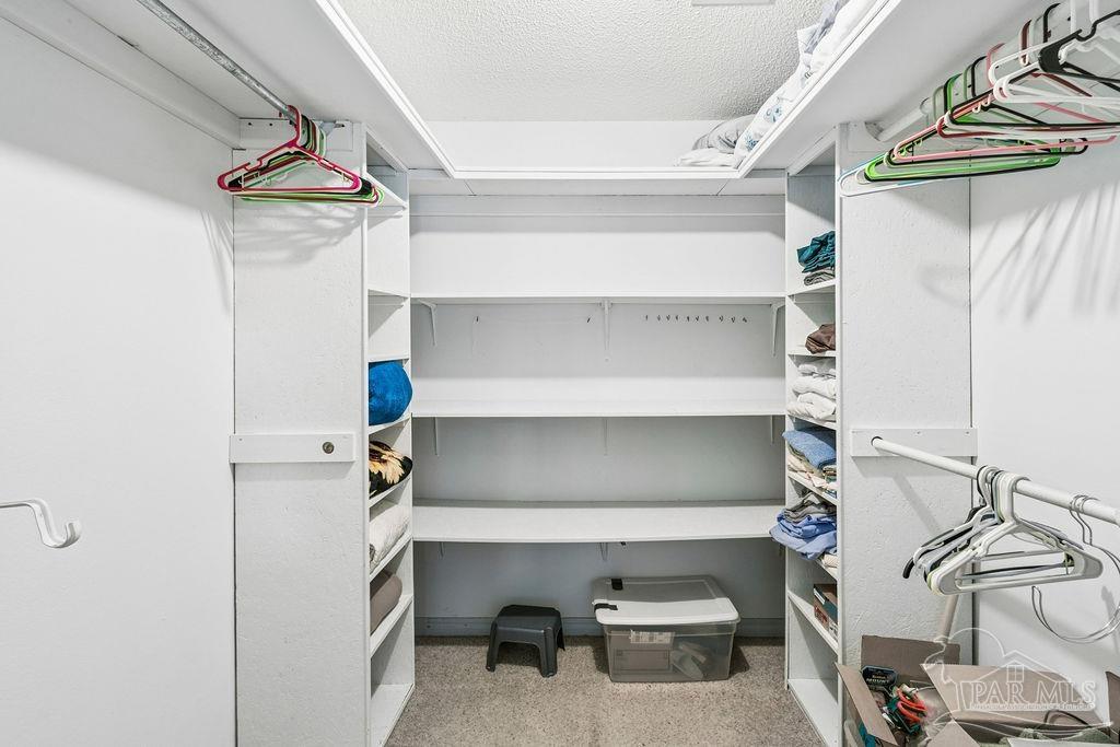 8938 Pioneer Road Holt, FL 32564 - Photo 20 of 44 a view of storage and utility room with racks on the wall
