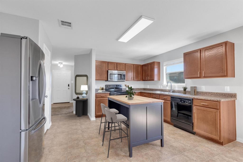 9301 Bellgrove Court Killeen, TX 76542 - Photo 8 of 22 a kitchen with stainless steel appliances granite countertop a refrigerator and a stove top oven