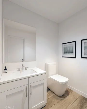 a bathroom with a sink mirror and toilet