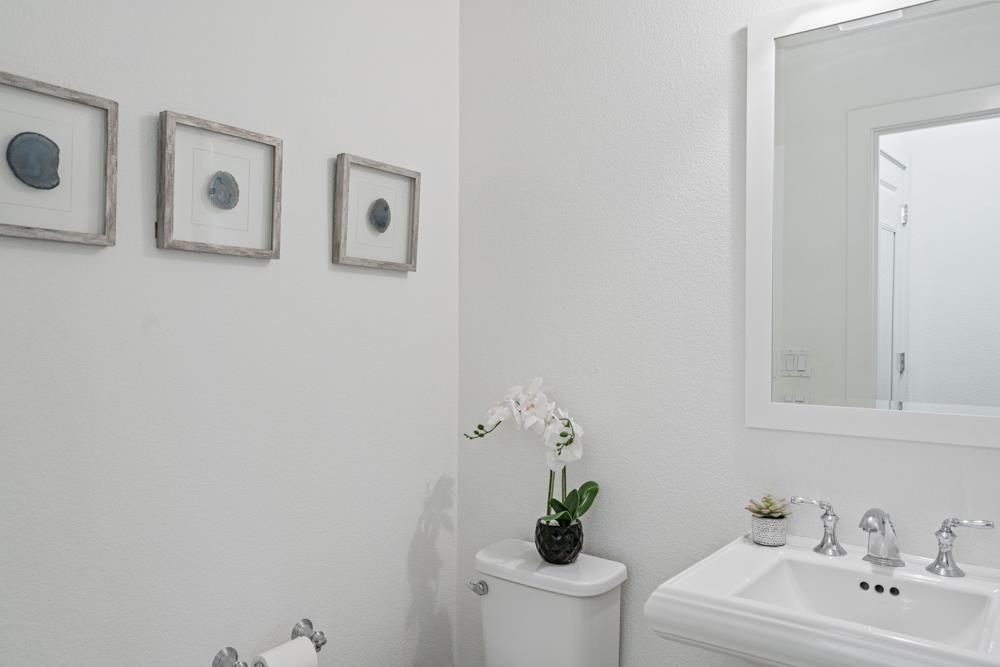 47236 Cavanaugh Common Fremont, CA 94539 - Photo 21 of 52 a bathroom with a sink mirror and toilet