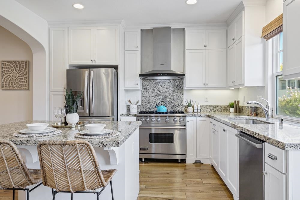 47236 Cavanaugh Common Fremont, CA 94539 - Photo 9 of 52 a kitchen with stainless steel appliances granite countertop a stove a sink and a refrigerator