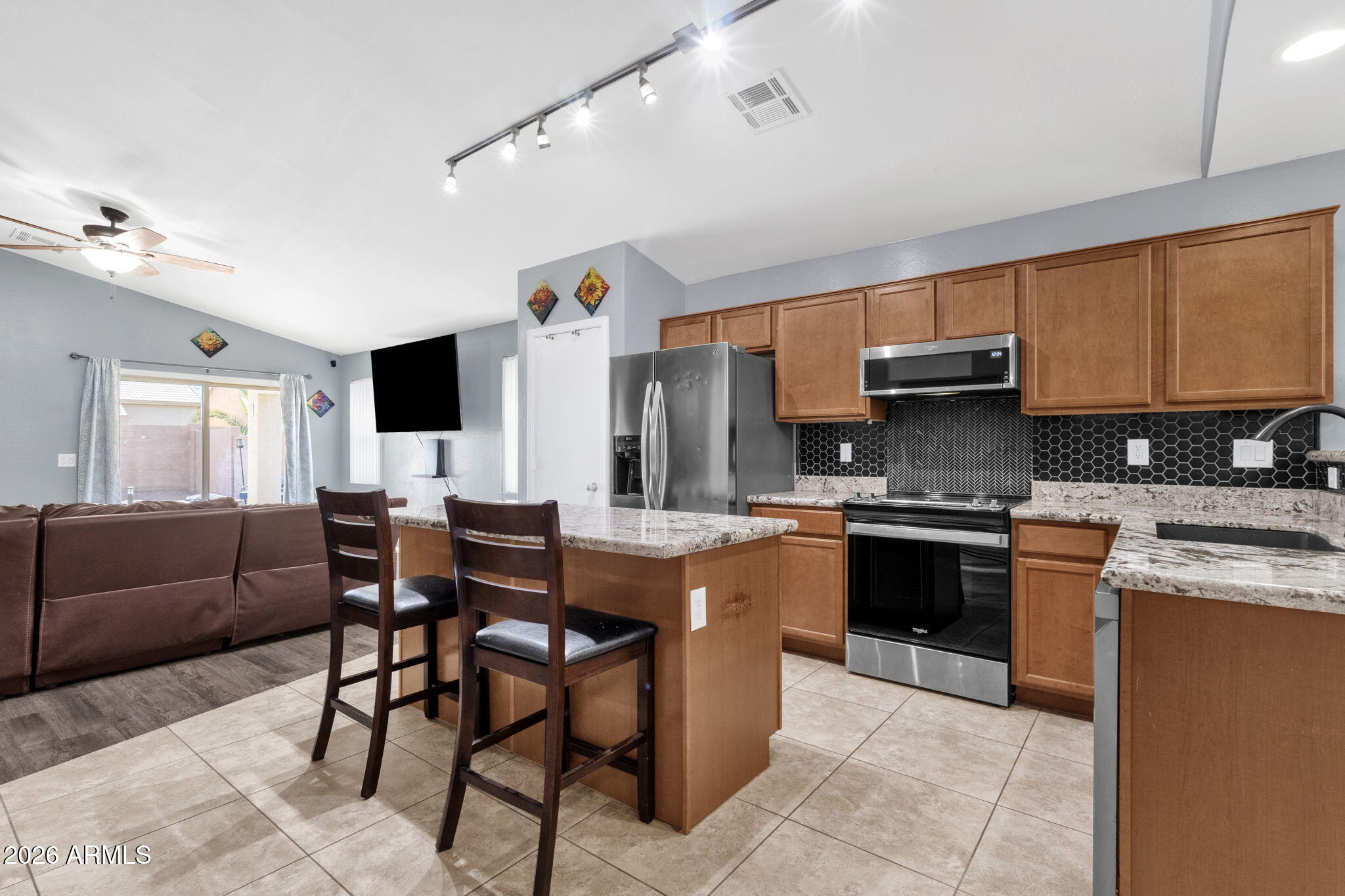 4629 West Carson Road Laveen, AZ 85339 - Photo 10 of 37 a kitchen with stainless steel appliances granite countertop a sink and cabinets