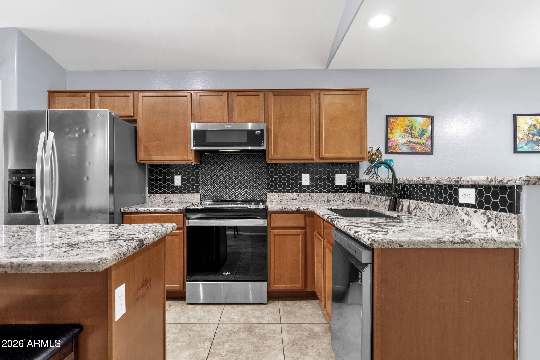 4629 West Carson Road Laveen, AZ 85339 - Photo 14 of 37 a kitchen with stainless steel appliances granite countertop a sink stove and refrigerator