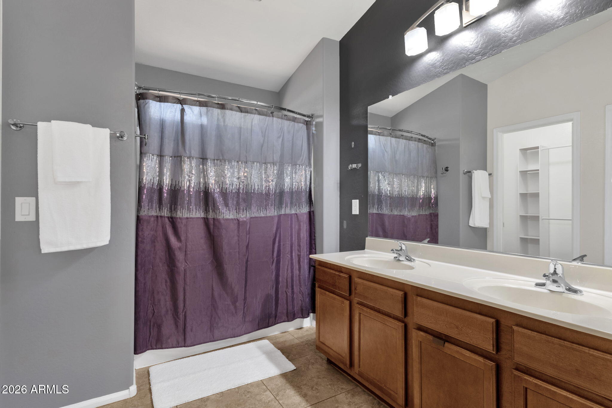 4629 West Carson Road Laveen, AZ 85339 - Photo 25 of 37 a bathroom with a double vanity sink mirror and shower