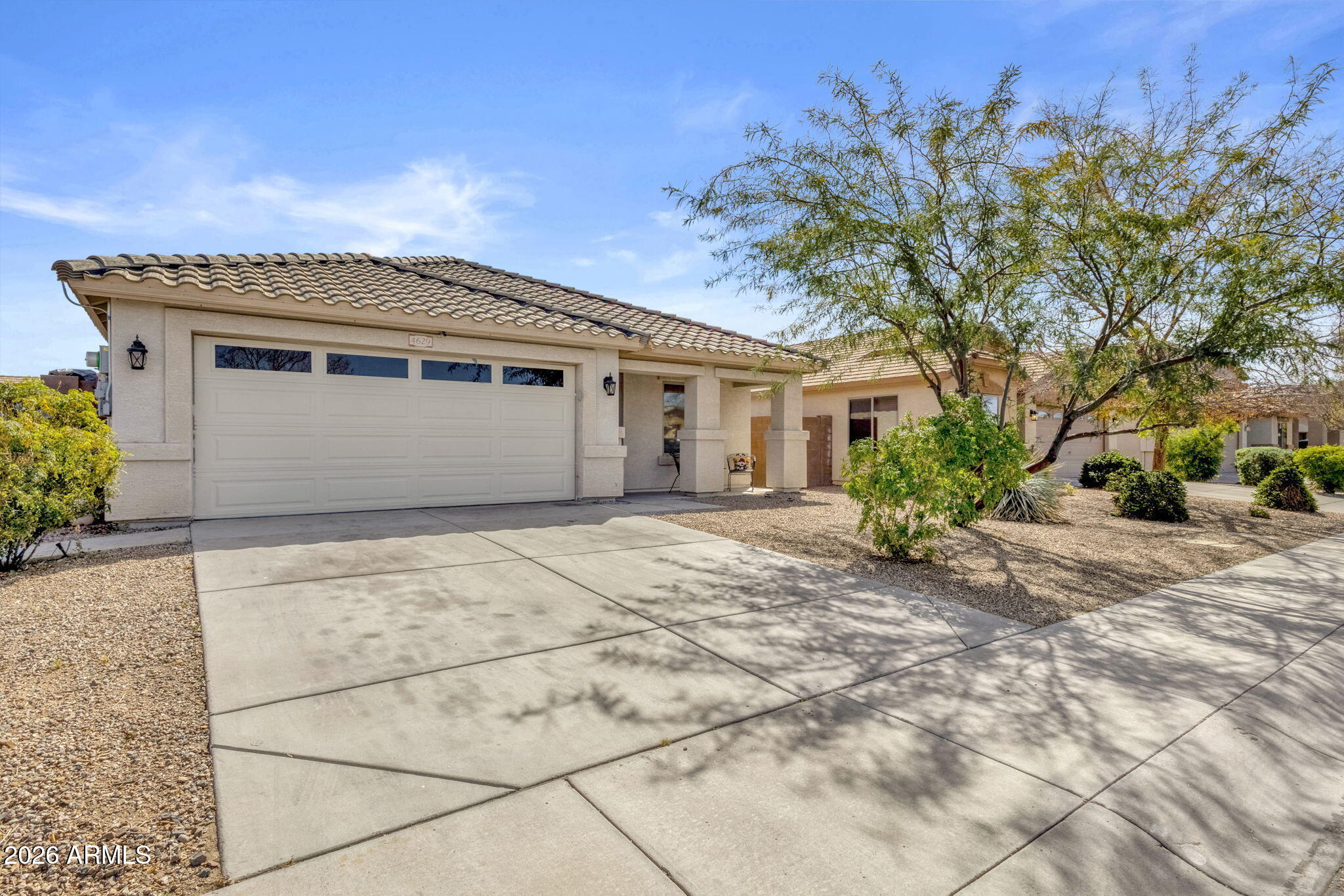 4629 West Carson Road Laveen, AZ 85339 - Photo 2 of 37 a front view of a house with a yard and garage