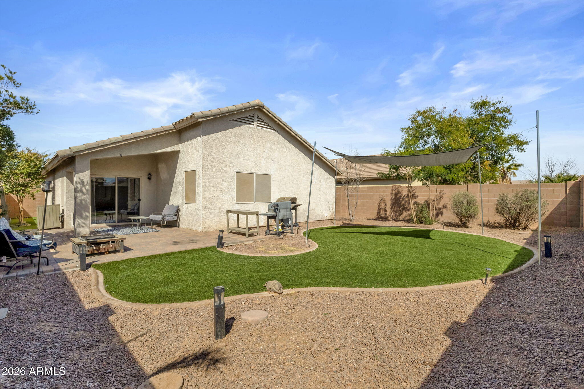 4629 West Carson Road Laveen, AZ 85339 - Photo 34 of 37 a view of a house with backyard sitting area and garden