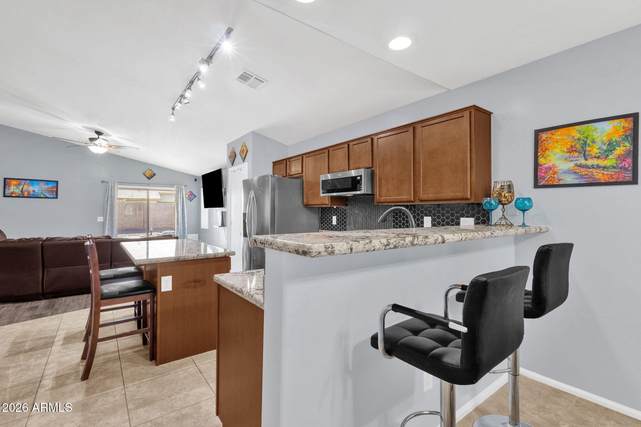 4629 West Carson Road Laveen, AZ 85339 - Photo 9 of 37 a kitchen with stainless steel appliances granite countertop a sink and a refrigerator