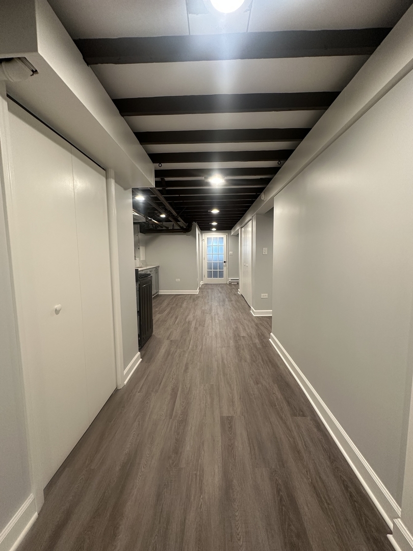 3016 South Throop Street, Unit GARDEN Chicago, IL 60608 - Photo 5 of 13 a view of empty room with wooden floor