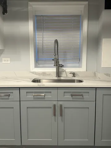 a sink with white cabinets