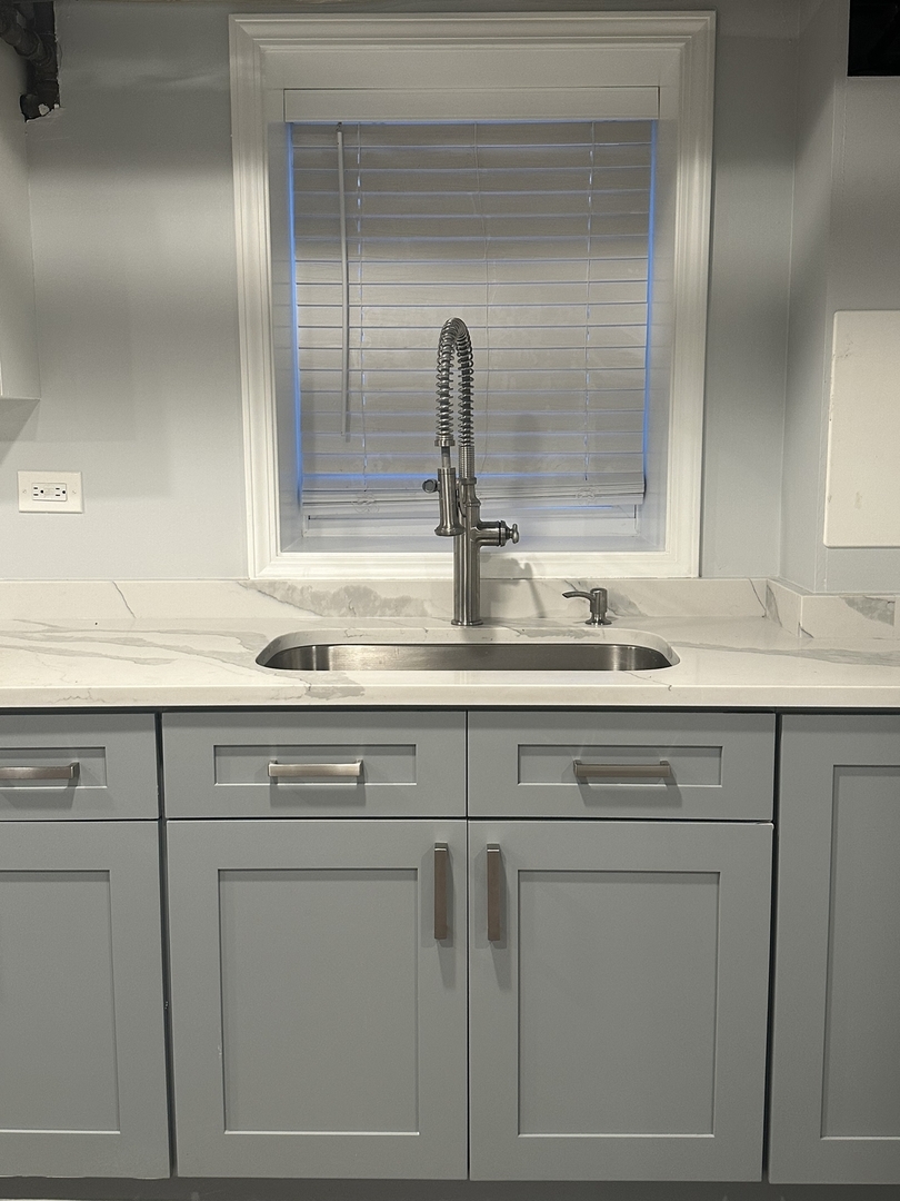 3016 South Throop Street, Unit GARDEN Chicago, IL 60608 - Photo 7 of 13 a sink with white cabinets