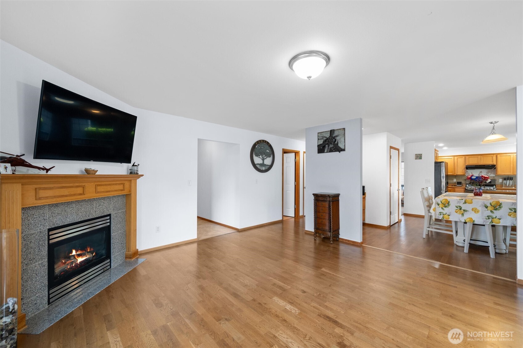 1877 Emerald Way Lynden, WA 98264 - Photo 11 of 38 a view of a livingroom with furniture a fireplace wooden floor and staircase