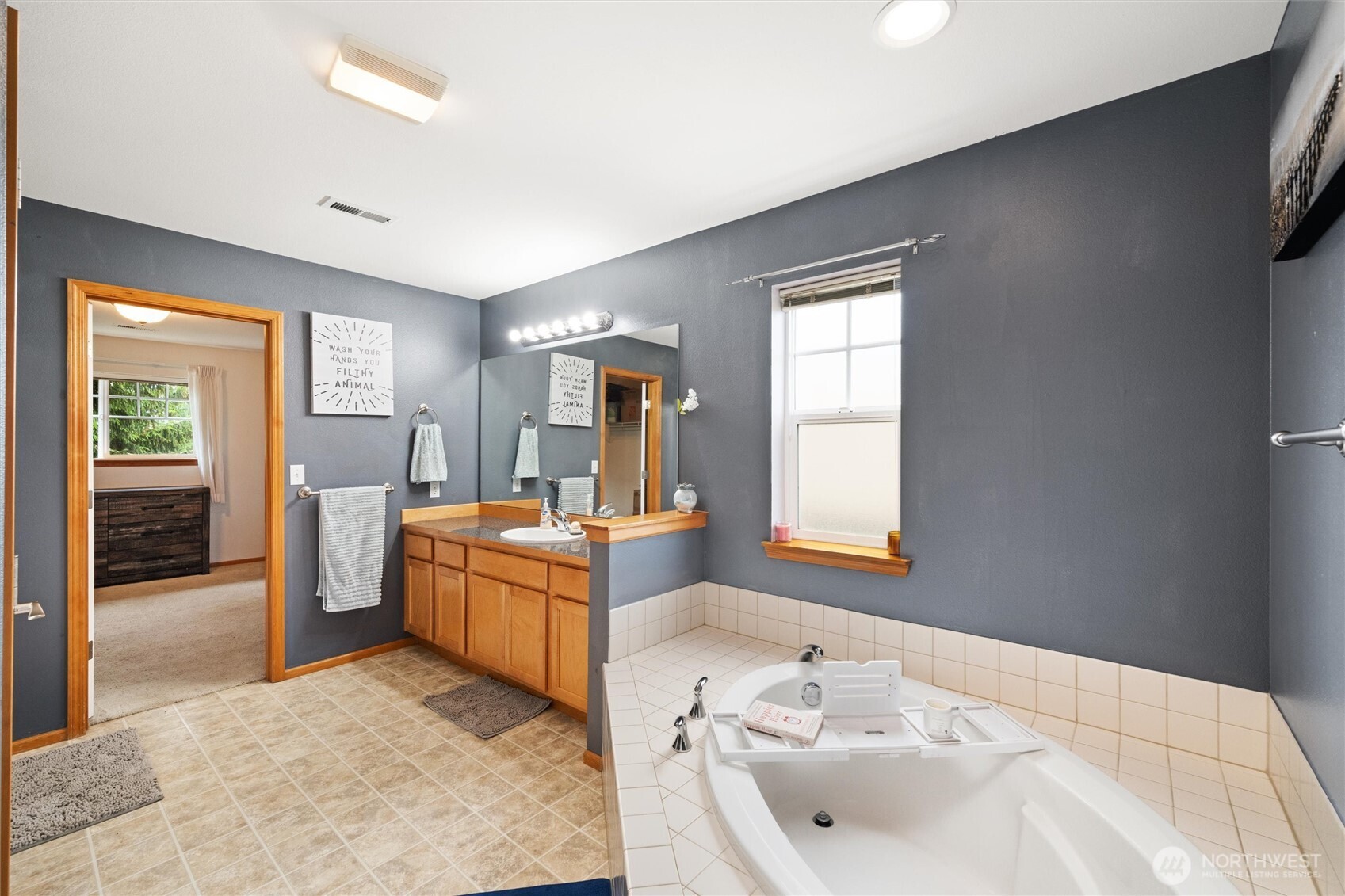 1877 Emerald Way Lynden, WA 98264 - Photo 22 of 38 a bathroom with a sink a vanity and mirror
