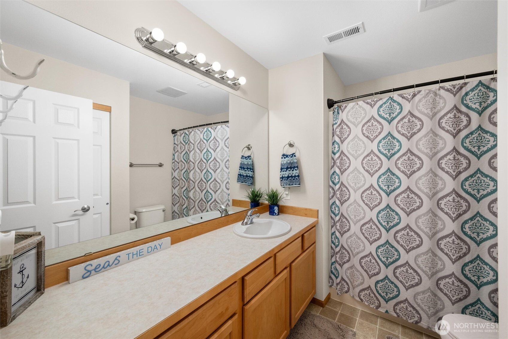 1877 Emerald Way Lynden, WA 98264 - Photo 27 of 38 a bathroom with a double vanity sink mirror and shower