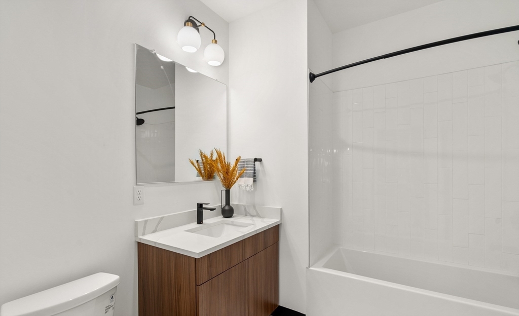 600 Broadway, Unit 608 Chelsea, MA 02150 - Photo 11 of 32 a bathroom with a sink toilet and shower