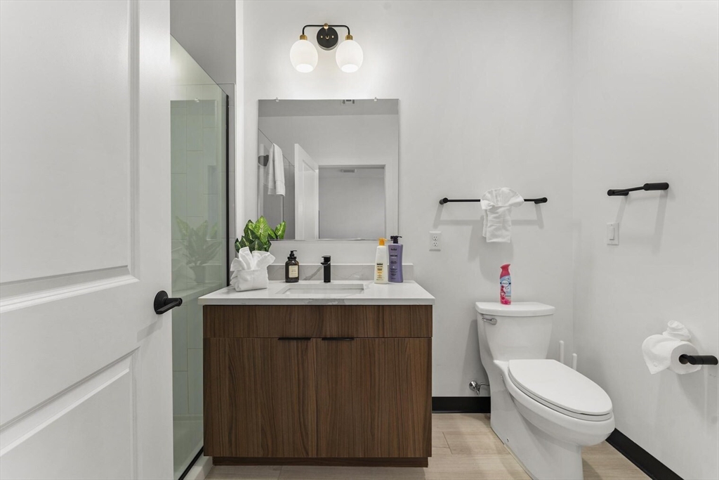 600 Broadway, Unit 608 Chelsea, MA 02150 - Photo 13 of 32 a bathroom with a toilet sink and mirror