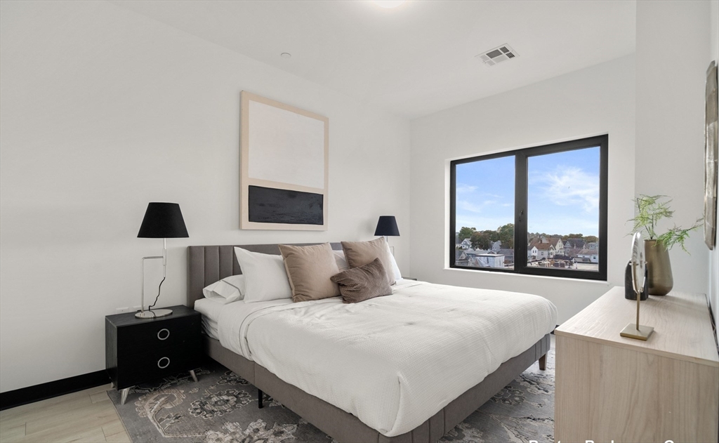 600 Broadway, Unit 608 Chelsea, MA 02150 - Photo 6 of 32 a bedroom with a bed and a large window