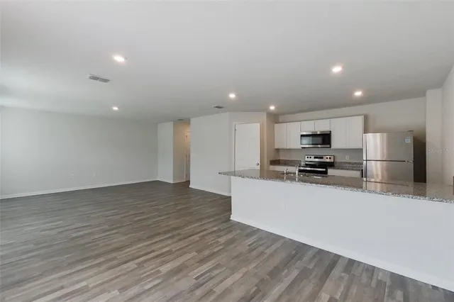 a view of kitchen with wooden floor and window