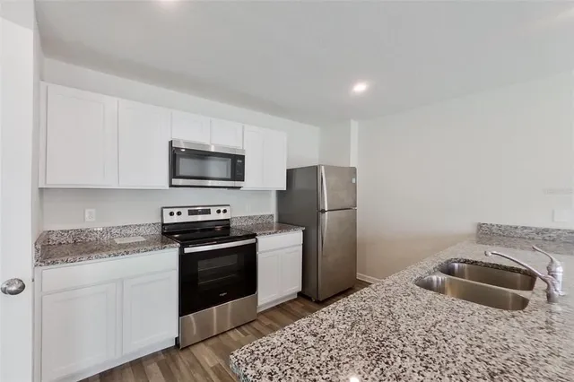 a kitchen with a sink stove and refrigerator
