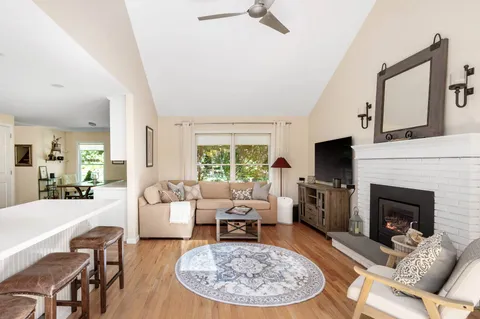a living room with furniture a fireplace and a flat screen tv