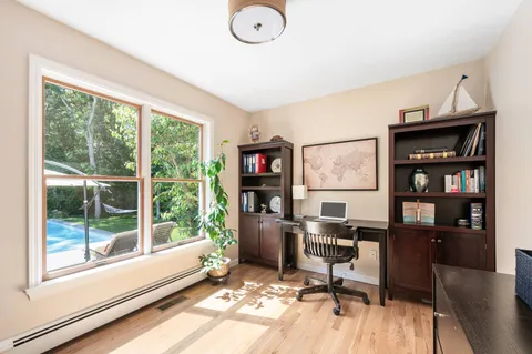 a workspace with furniture hardwood and a window