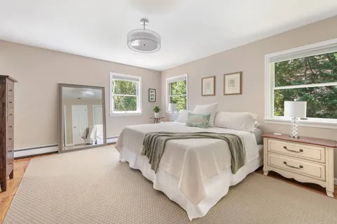 a spacious bedroom with a bed and a large window