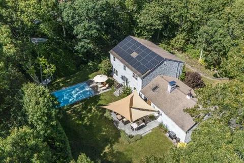 an aerial view of a house with a yard