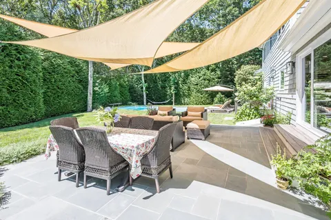 a view of a patio with table and chairs and potted plants