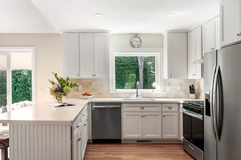 a kitchen with a sink stove and refrigerator