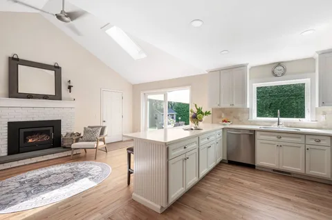 a open kitchen with sink cabinets and wooden floor