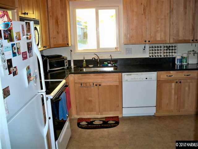 550 Nancy Circle, Unit 1 Reno, NV 89503 - Photo 5 of 10 a kitchen with a sink a stove and cabinets