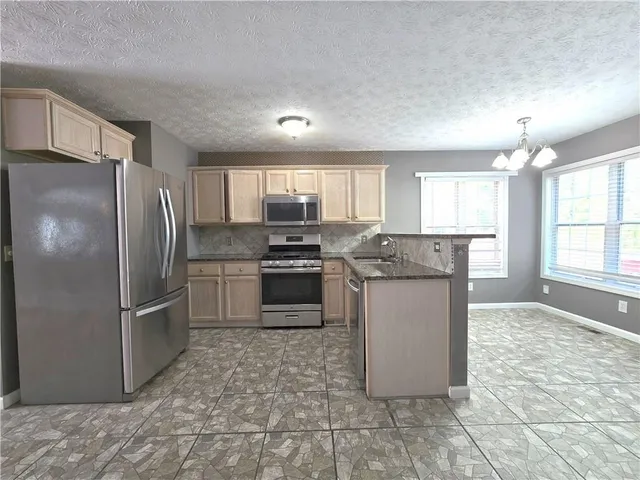 a kitchen with a sink and a window