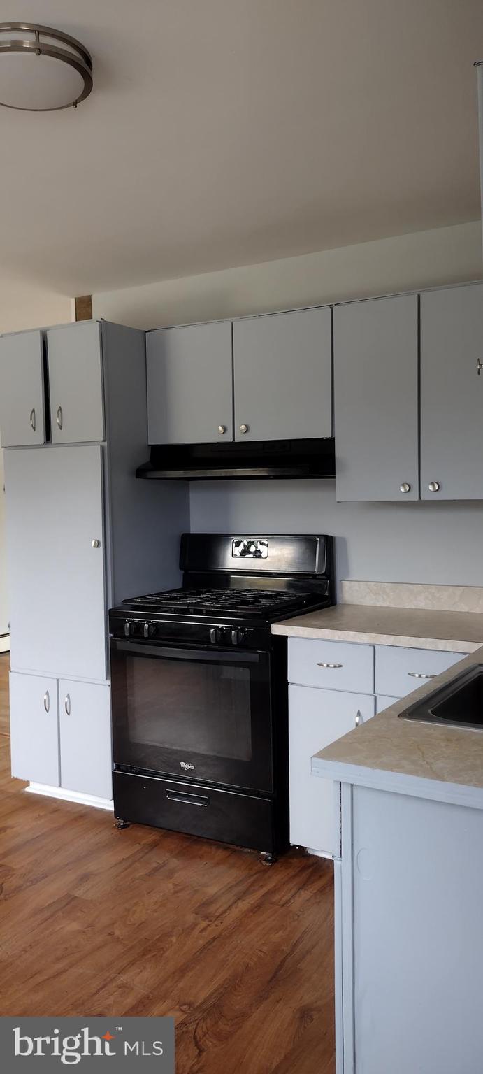 25853 Quinton Road Mardela Springs, MD 21837 - Photo 32 of 53 a kitchen with stainless steel appliances a stove a sink and a microwave
