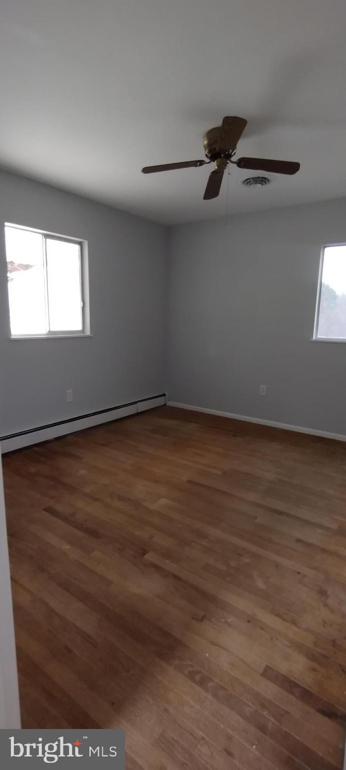 25853 Quinton Road Mardela Springs, MD 21837 - Photo 36 of 53 an empty room with wooden floor cabinet and windows