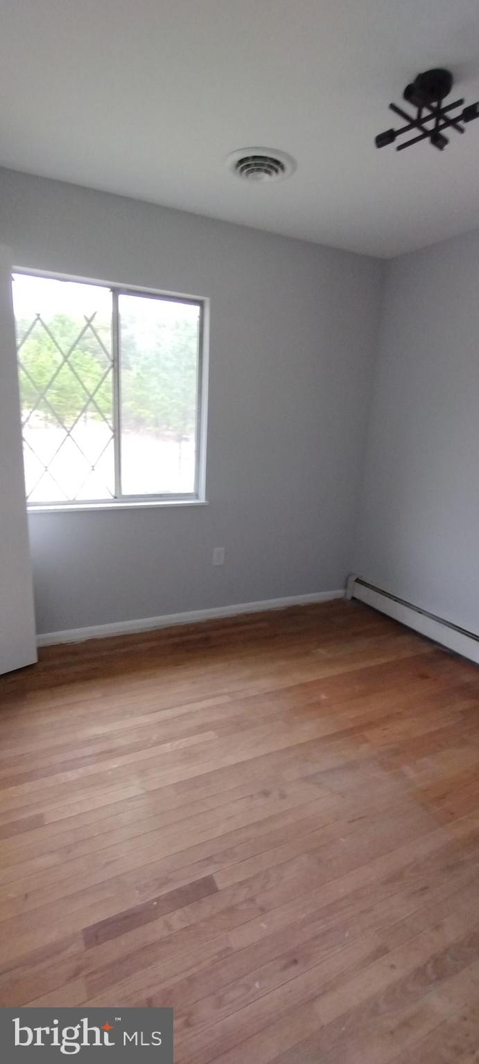 25853 Quinton Road Mardela Springs, MD 21837 - Photo 49 of 53 wooden floor in an empty room with a window