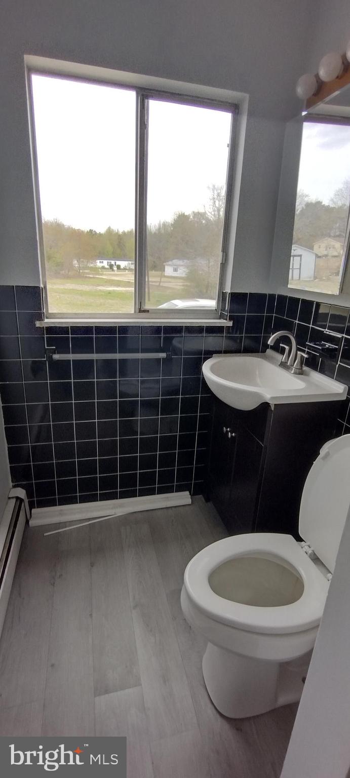 25853 Quinton Road Mardela Springs, MD 21837 - Photo 50 of 53 a bathroom with a toilet a sink and a window