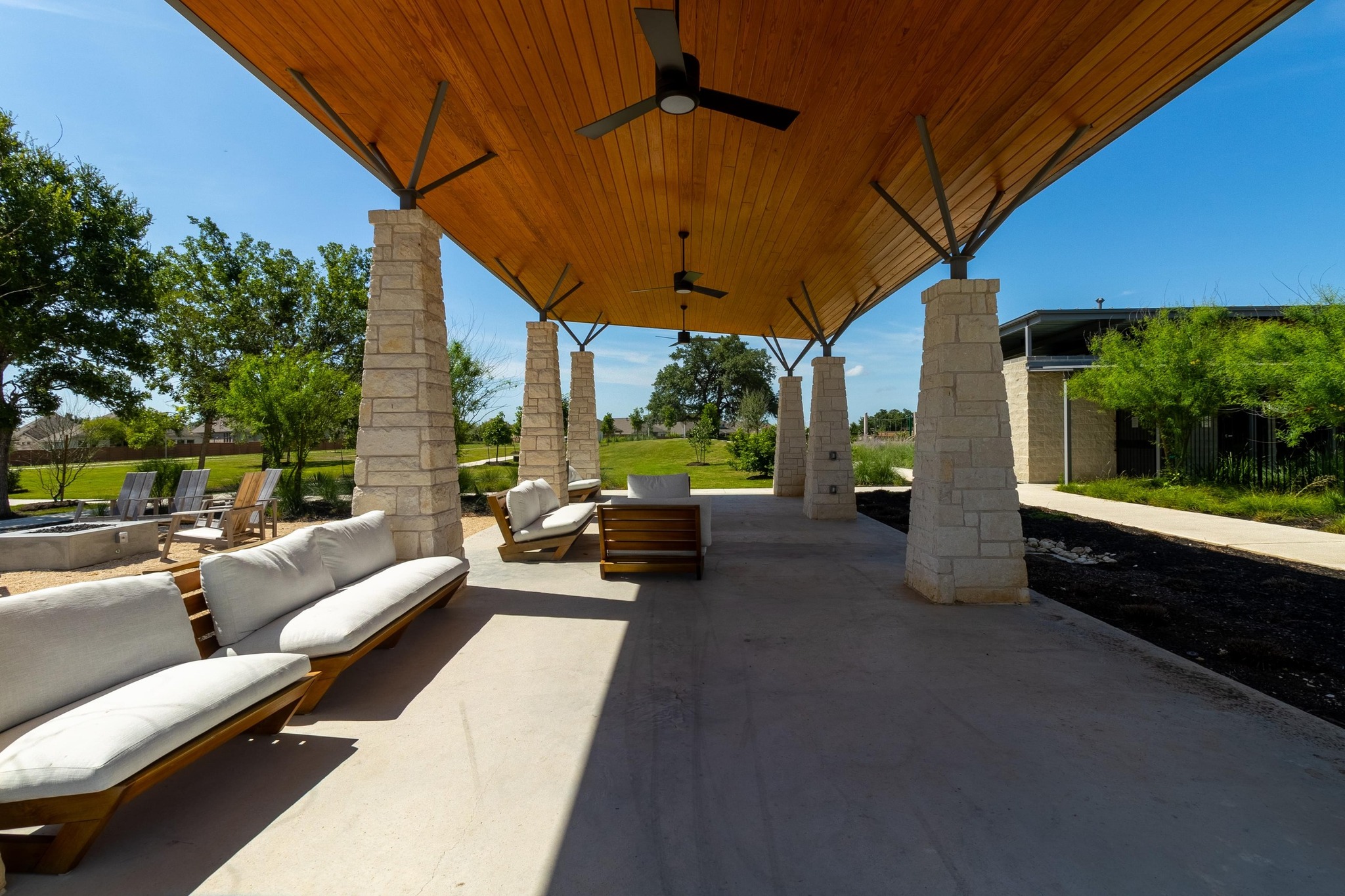 271 Tubman Drive Kyle, TX 78640 - Photo 35 of 40 a view of a patio with couches table and chairs under an umbrella
