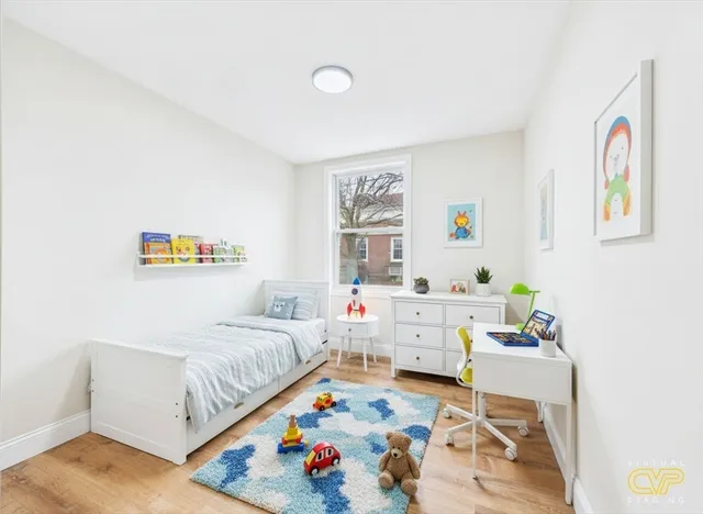 a bedroom with furniture and a baby crib