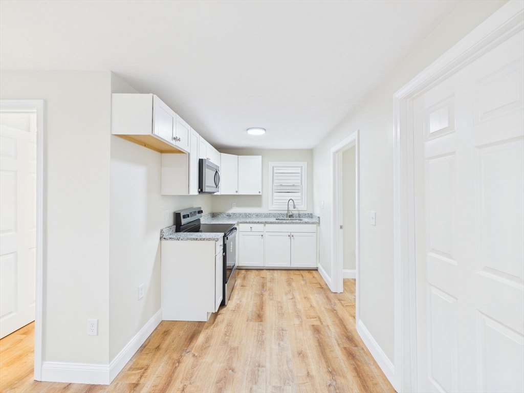 24 Middle Street Fairhaven, MA 02719 - Photo 26 of 38 a kitchen with a sink cabinets and wooden floor