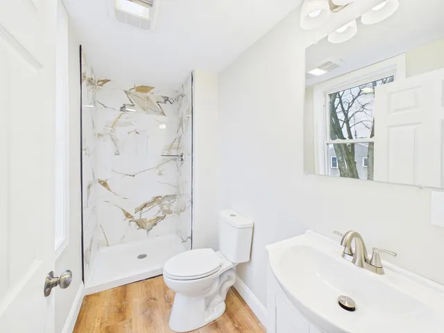 a bathroom with a toilet sink and shower