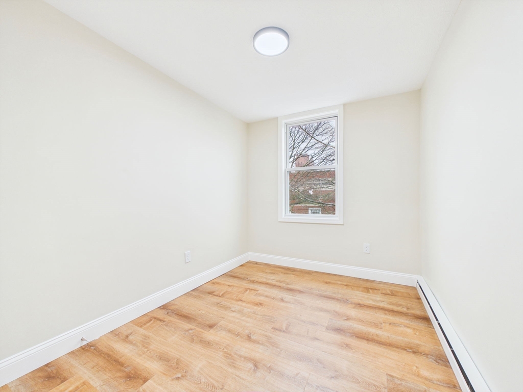 24 Middle Street Fairhaven, MA 02719 - Photo 32 of 38 an empty room with a workbench
